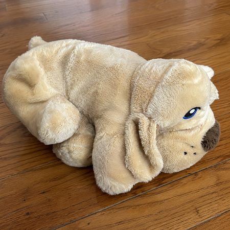 Plush dog toy on a wooden floor