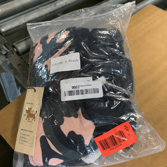Packaged black gloves with brand labels on a cardboard surface
