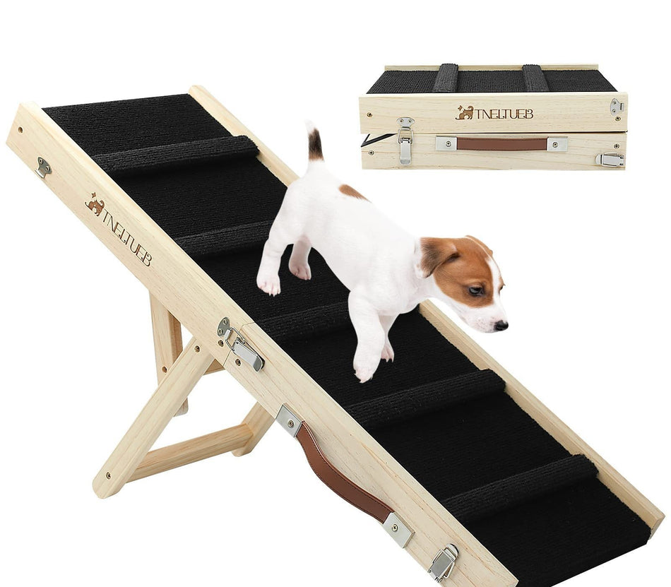 Dog using a wooden pet ramp with a Newfie brand logo, and a wooden carrying case in the background.
